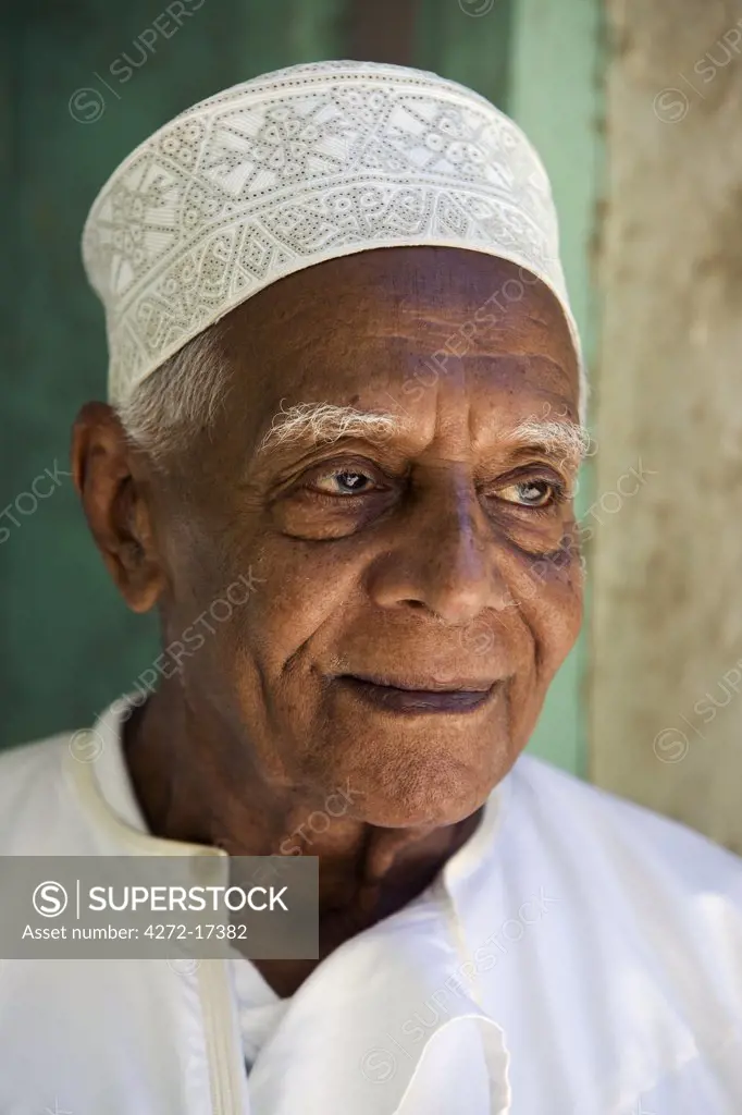 Kenya, Lamu Island, Lamu. An old resident of Lamu town dressed in his kofia or embroidered Muslim hat.