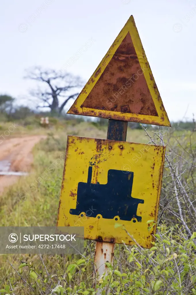 Kenya, Tsavo. Old railway crossing sign near the approach to Tsavo Railway Station. Tsavo was the place where two man-eating lions devoured twenty-eight Indian coolies and many African workers in 1898, holding up construction of a bridge on the Uganda Railway for several months.
