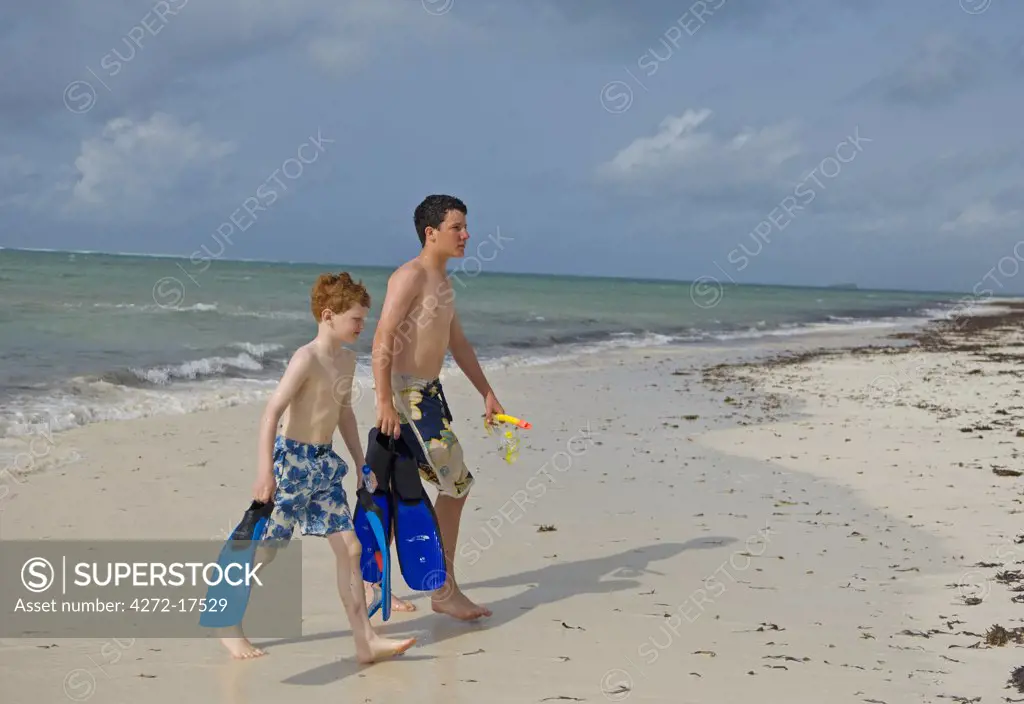 Kenya, Watamu. Two boys with snorkels and fins on Watamu beach.