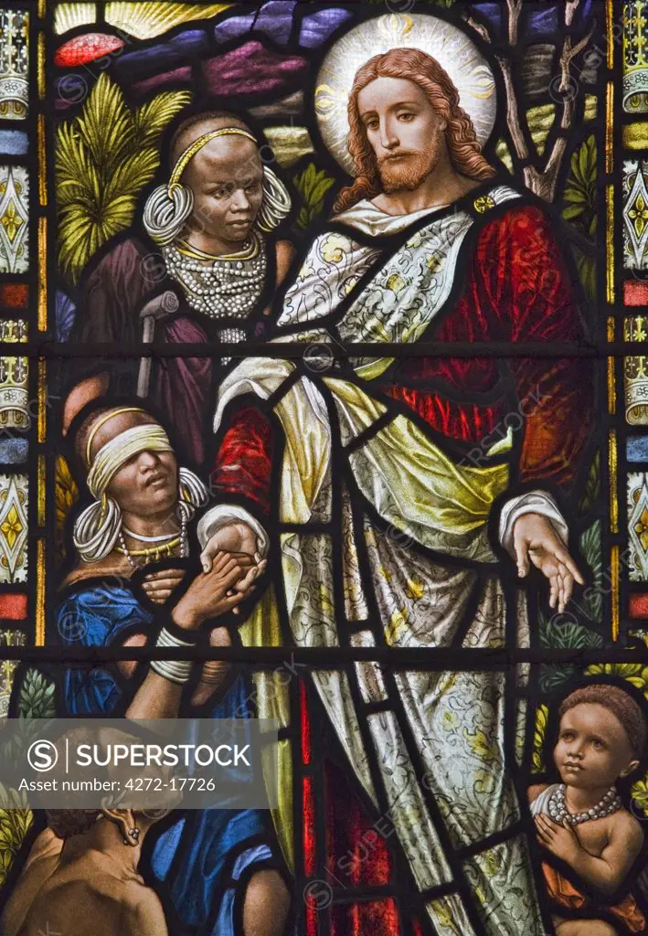 Kenya, Kiambu, Kikuyu. One of the stained glass windows in the Church of the Torch near Kikuyu depicts Jesus and his flock of Kikuyu women and children in traditional attire.  The church is the oldest Presbyterian church in East Africa.  The first service was held there in 28th January 1909.