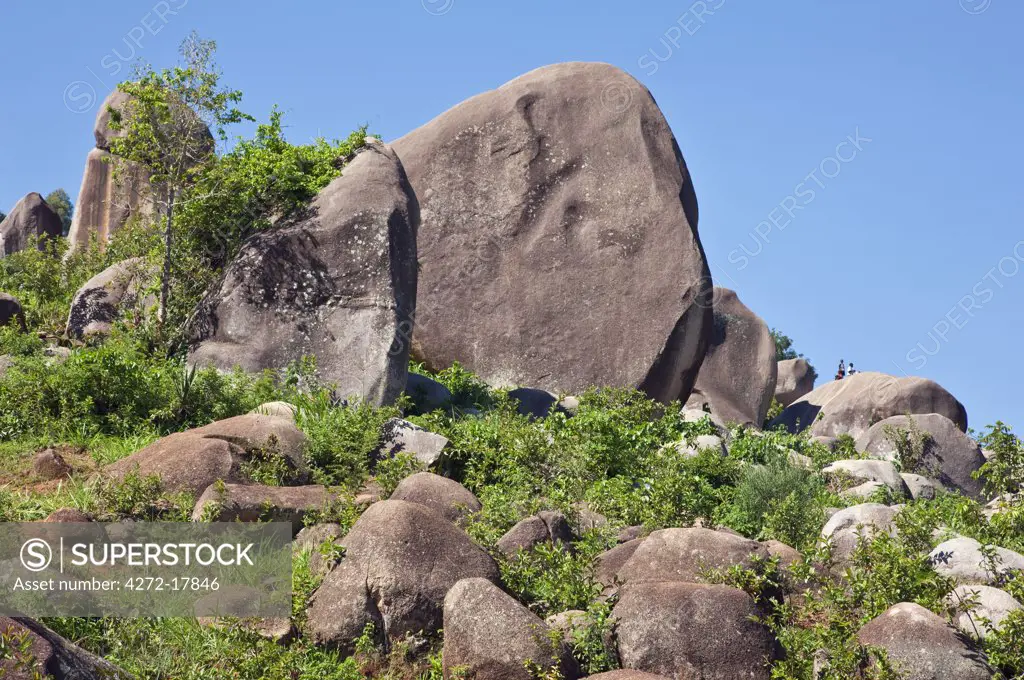 Kenya. Children play among giant granite boulders in Western Kenya.