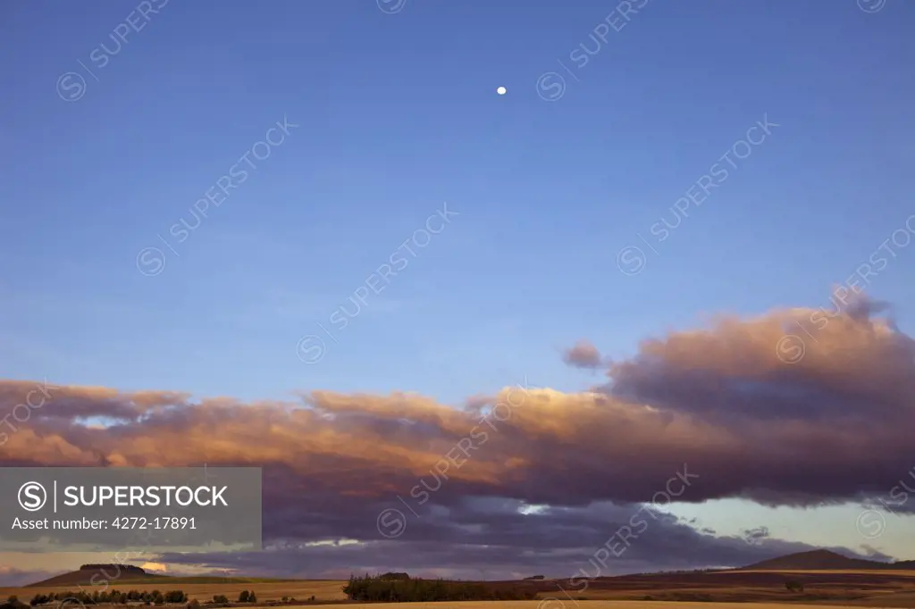 Kenya,Timau. Last light over rolling farmland at Timau with a full moon high in the sky.