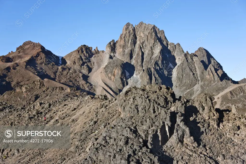 Kenya. Climbers scale a ridge towards the peaks of Mount Kenya.  Retreating glaciers and the lack of snow highlights the effects of global warming on the equator.