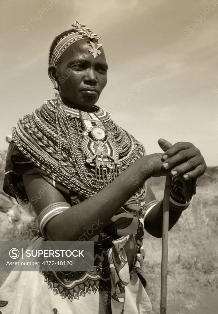 Kenya, Laikipia.  A Samburu woman wears layers of beaded necklaces and an elaborate beaded headdress.