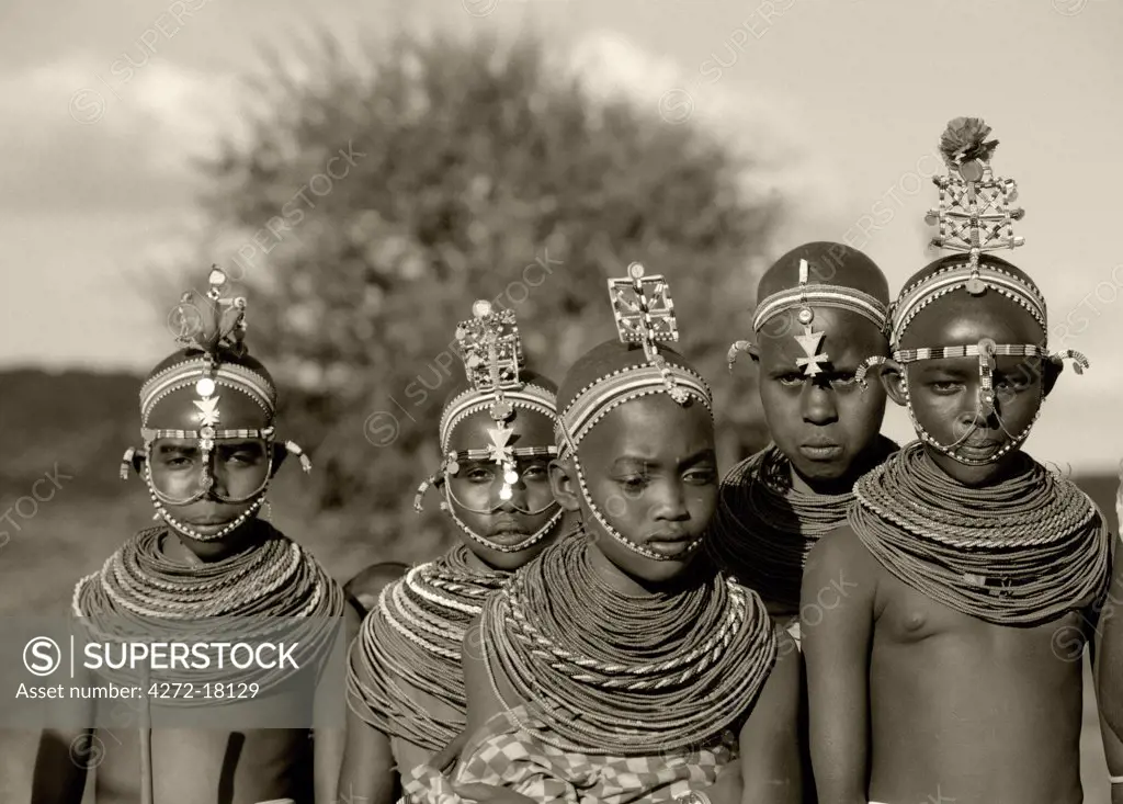 Kenya,Laikipia.  Laikipiak Maasai girls dressed in decorative headdresses and necklaces to attend a wedding.