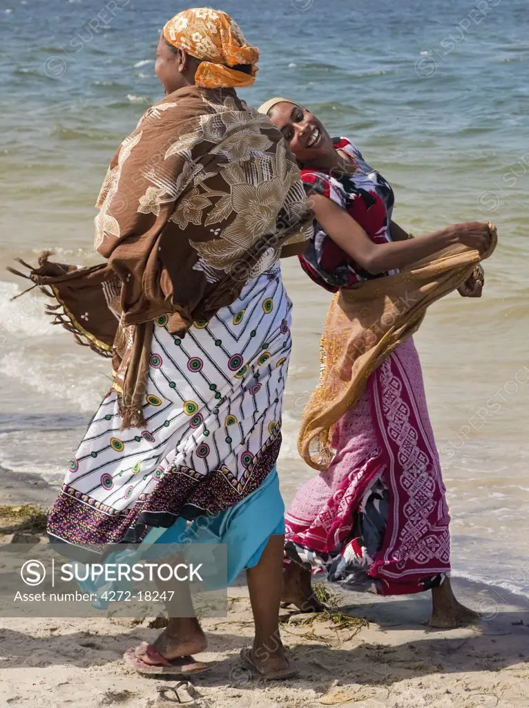 Kenya. Two excited women after watching one of the bi-annual dhow races in Lamu.