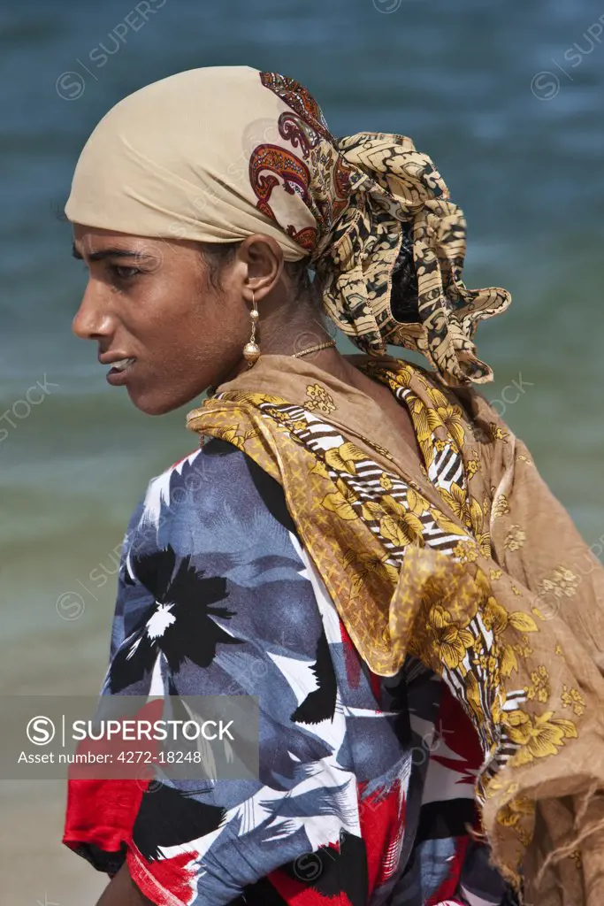 Kenya. A Muslim woman from Lamu wearing brightly coloured clothes.