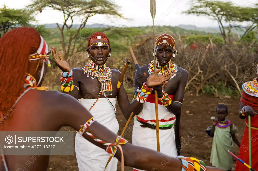 Kenya, Laikipia, Ol Malo. Samburu warriors sing, clap and dance in their traditional dress at a manyatta