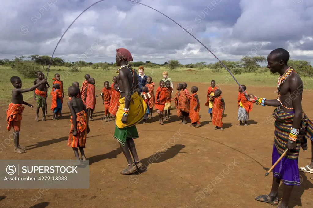 Kenya, Laikipia, Ol Malo. Children at Ol Malo school learn their ABCs by chanting while one of the children skips to the rythm.