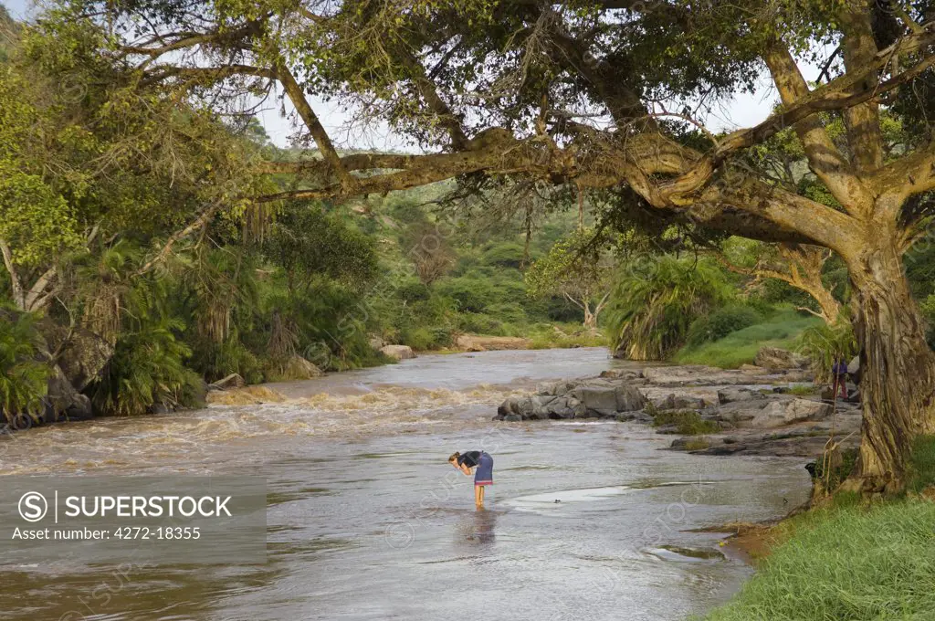 Kenya, Laikipia, Ol Malo. Washing in the Ewaso Nyiro River whilst camping on a camel safari from Ol Malo. (MR)
