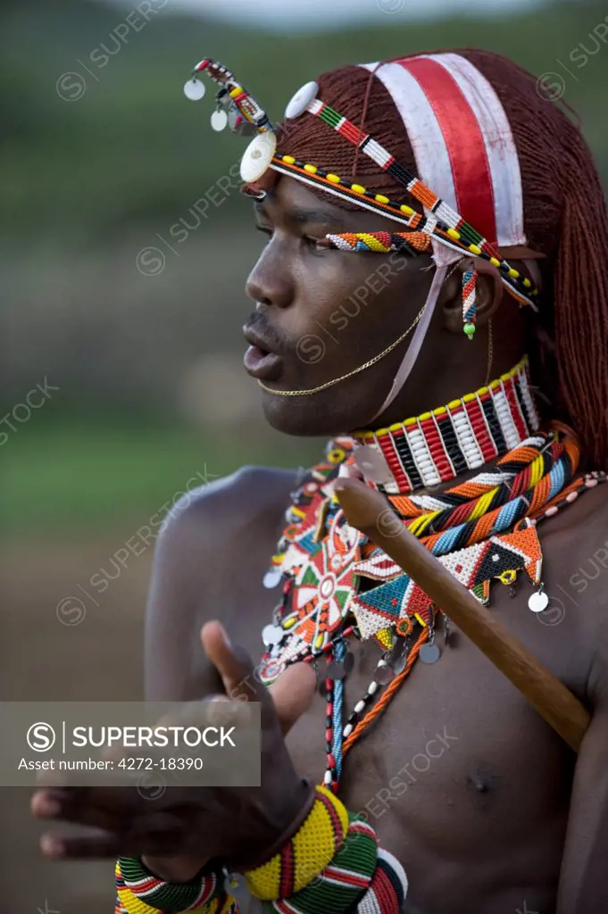 Kenya, Laikipia, Ol Malo.  A Samburu warrior sings and claps during a dance