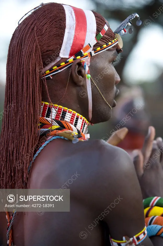 Kenya, Laikipia, Ol Malo.  A Samburu warrior's hair is ochred and in braids at a dance