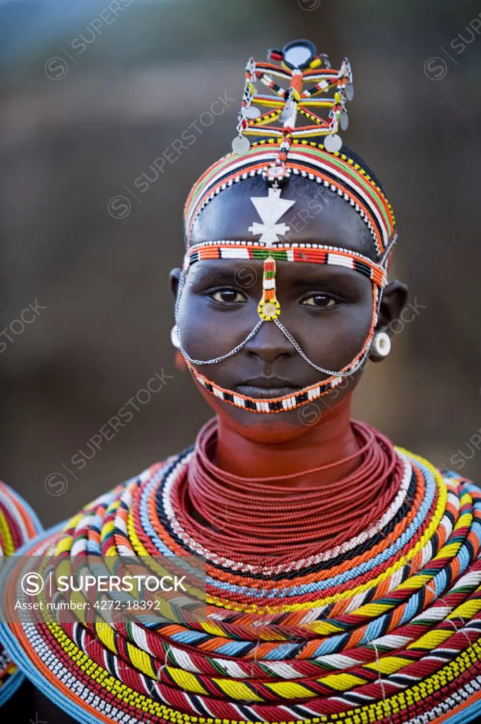 Kenya, Laikipia, Ol Malo.  Young Samburu girl dressed in her traditional beaded necklaces and headress at a dance.