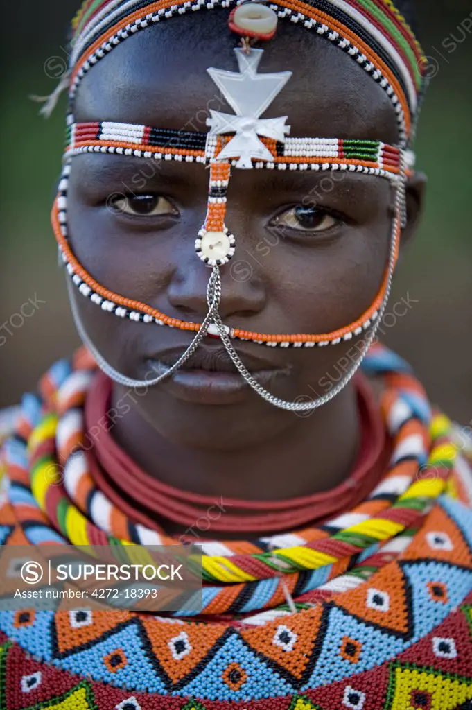 Kenya, Laikipia, Ol Malo.  Young Samburu girl dressed in her traditional beaded necklaces and headress at a dance.