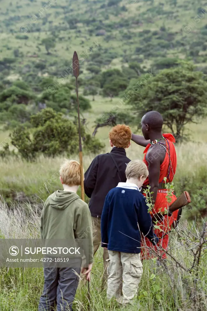 Kenya, Laikipia, Lewa Downs. A Wilderness Trails' Laikipiak Maasai guides  children on a bush walk. (MR)