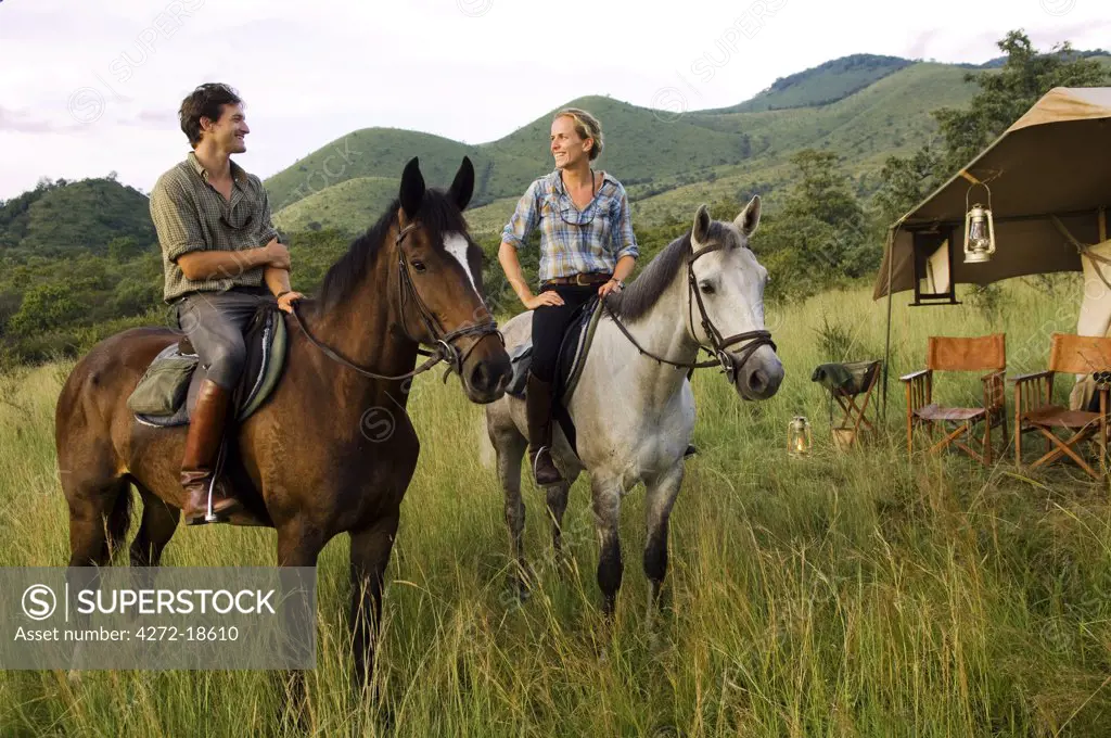 Kenya, Chyulu Hills, Ol Donyo Wuas.  Couple on a horse riding safari with Ride Africa in the Chyulu Hills (MR)