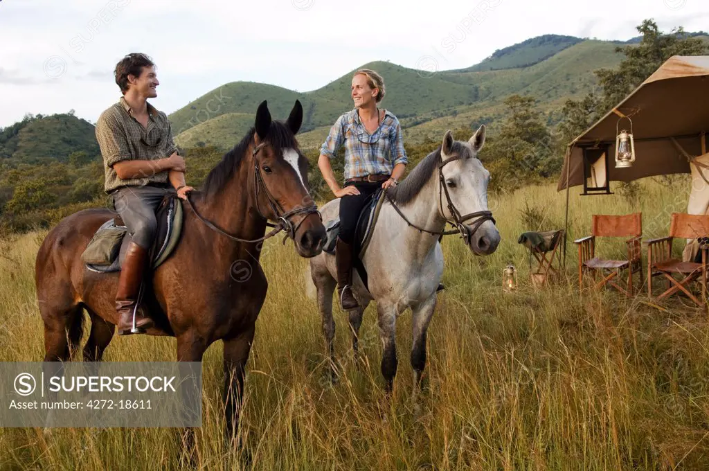Kenya, Chyulu Hills, Ol Donyo Wuas.  Couple on a horse riding safari with Ride Africa in the Chyulu Hills (MR)