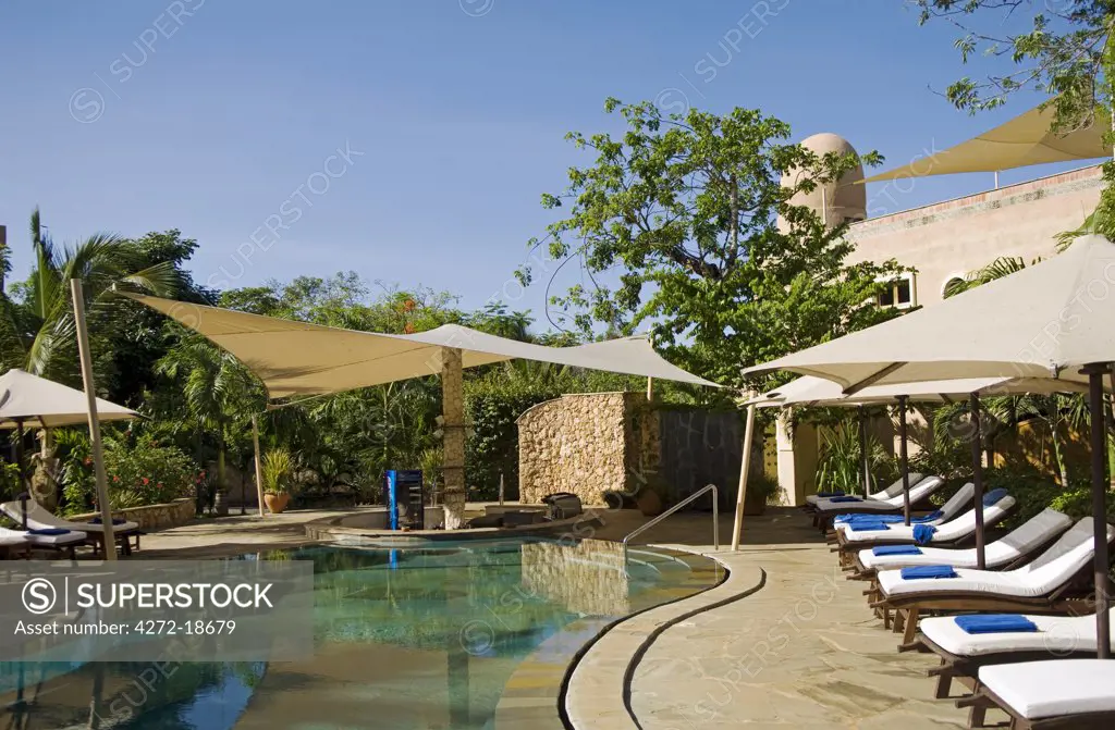 Kenya, Coast, Diani Beach. The swimming pool and sunken bar for the garden villas at Almanara Beach Resort.