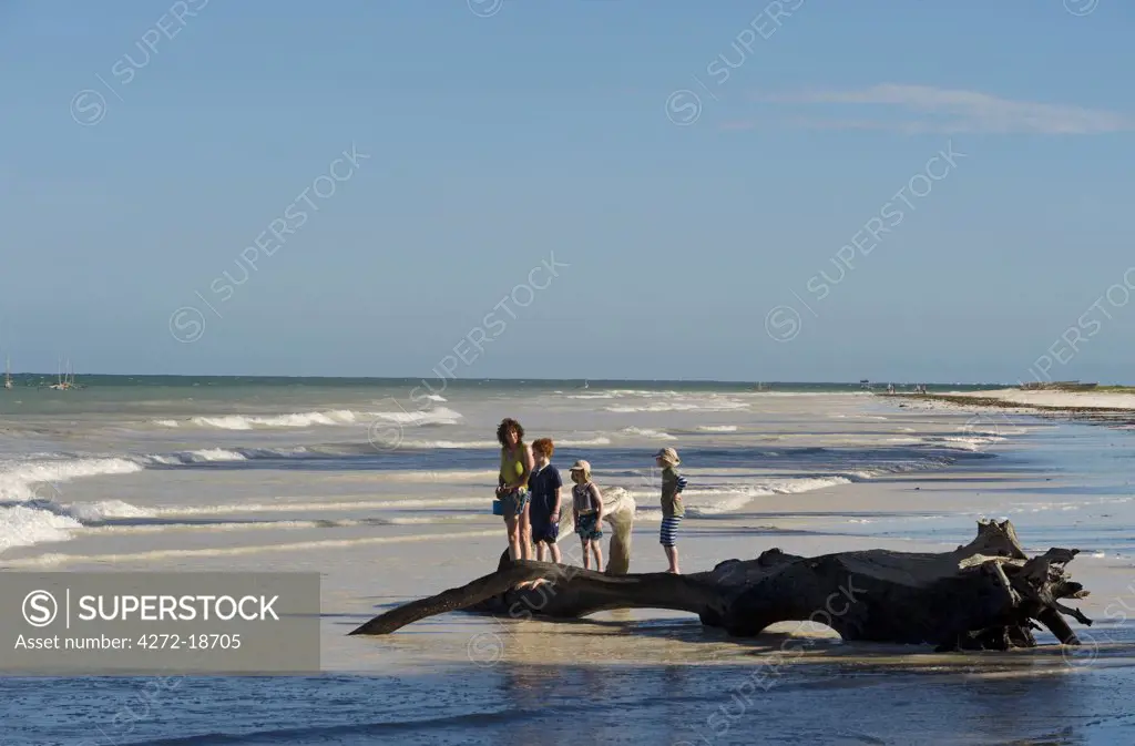 Kenya, Coast, Diani Beach.  Family enjoying the beach. (MR)