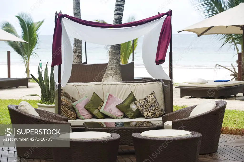 Kenya, Coast, Diani Beach.  Stylish sunloungers on the beach front at Almanara Beach Resort.