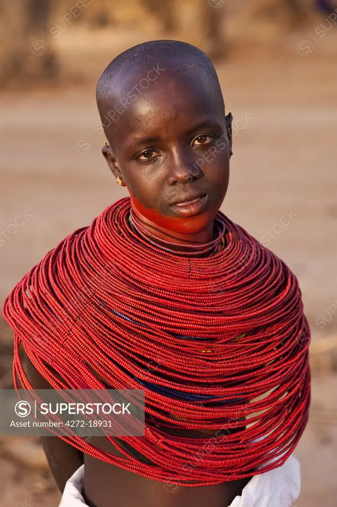 Kenya, Samburu District.  Young Samburu girl in traditional beaded necklaces.