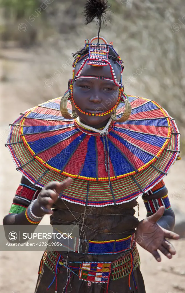 A young married Pokot woman wearing the traditional beaded ornaments of her tribe which denote her married status. Her lower belt is made with the metacarpus and metatarsal bones of dikdiks interspersed with beads. Kenya