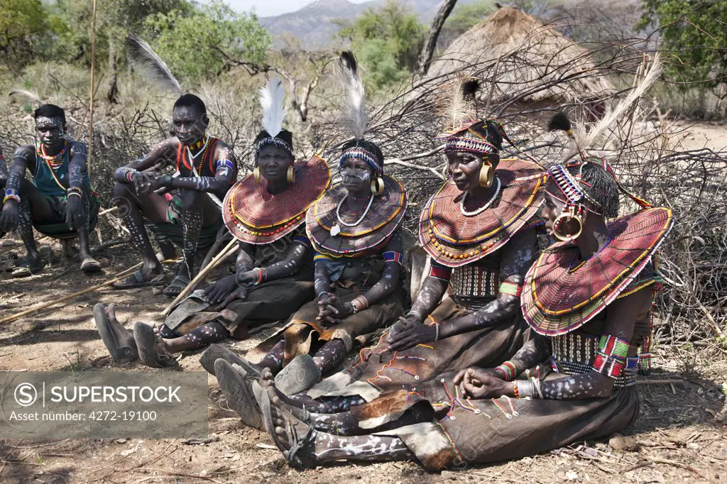 The Pokot have a small ceremony called Koyogho when a man pays his in-laws the balance of the agreed dowry for his wife.  This may take place many years after he marries her. His friend wait patiently for the conclusion of the ritual.