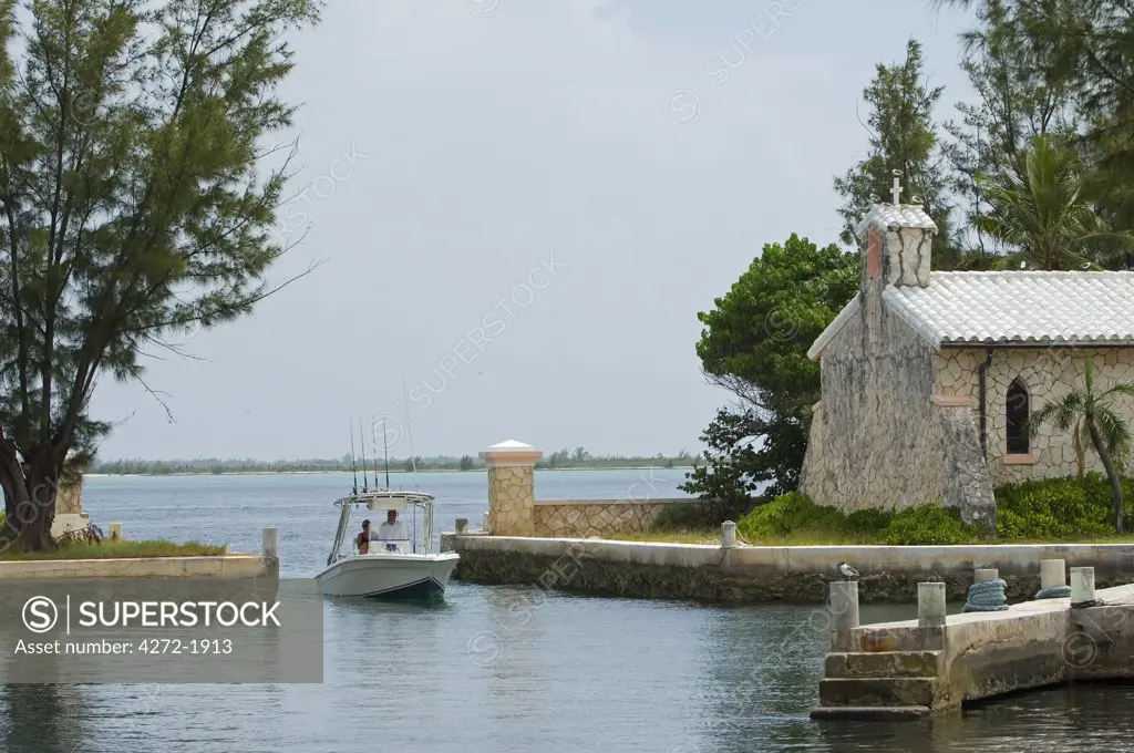 A boat enters the boat harbour on Little Whale Cay,,