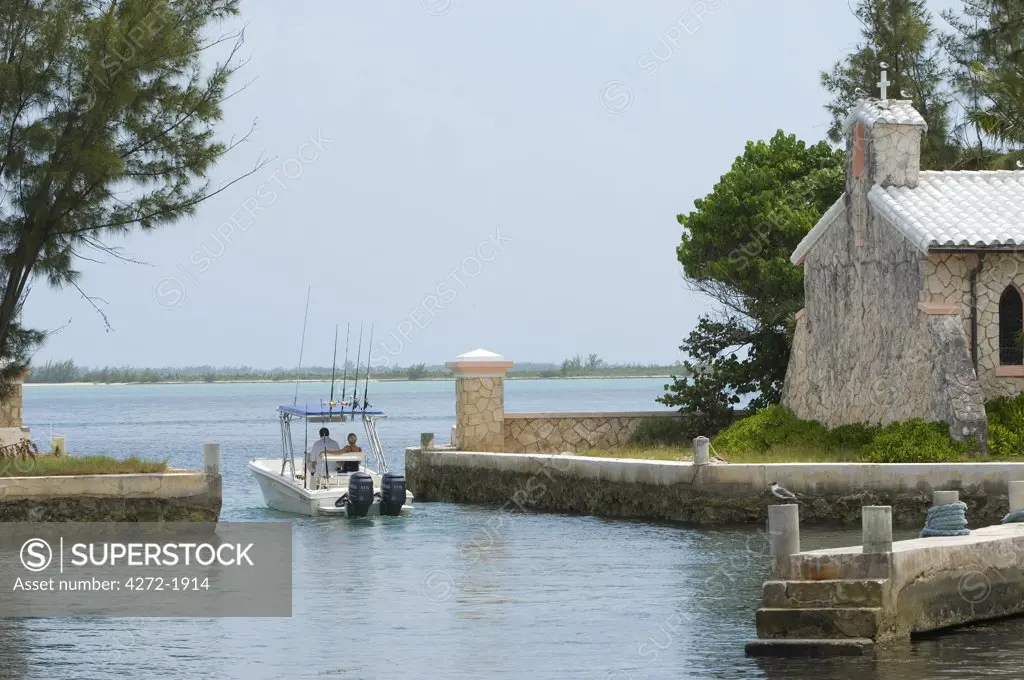 A boat leaves the boat harbour on Little Whale Cay