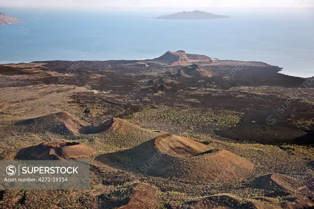 The lava barrier that separates the southern end of Lake Turkana from the Suguta Valley. South Island is in the distance while the extinct volcanic crater, Abil Agituk, is close to the lakeshore. The region is pockmarked with volcanic cones.