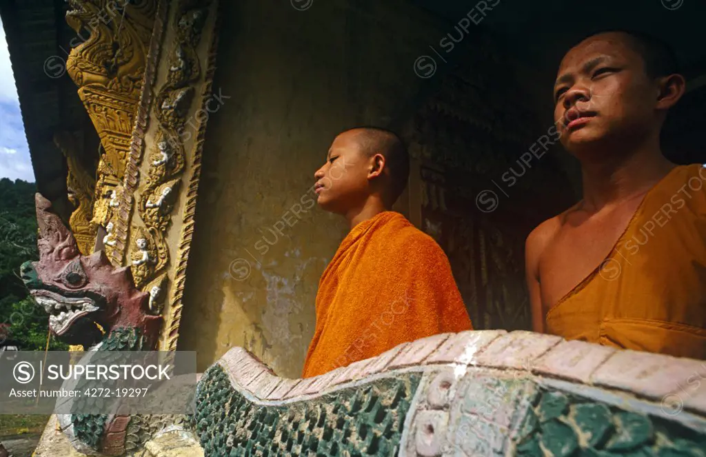 Laos, Vientiane Province, Pha Tong, nr Vang Vieng. Monks linger at a Buddhist temple at Pha Tong village, or Ban Pha Tong.