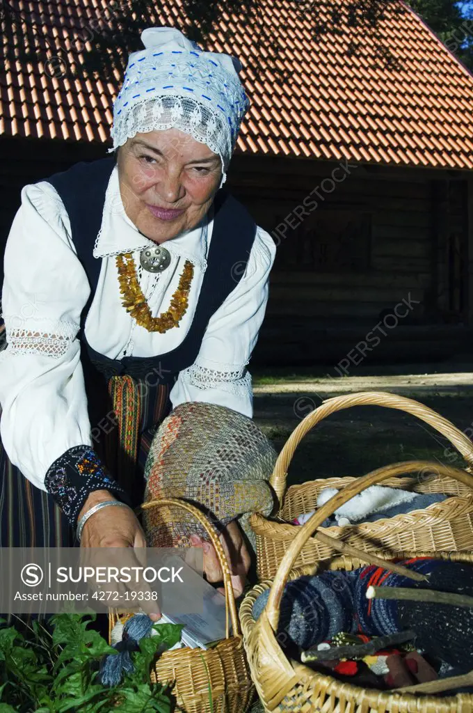 Woman in Traditional Dress with Handicrafts at the Latvian Ethnographic Open-Air Museum