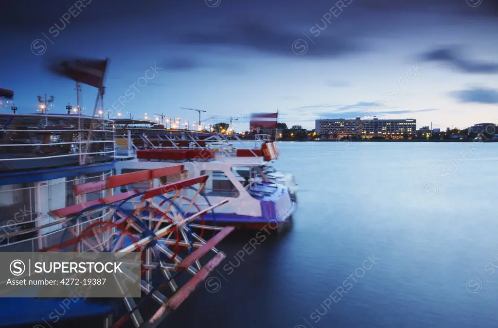 Tourist boats on Daugava River with Radisson Hotel in background, Riga, Latvia