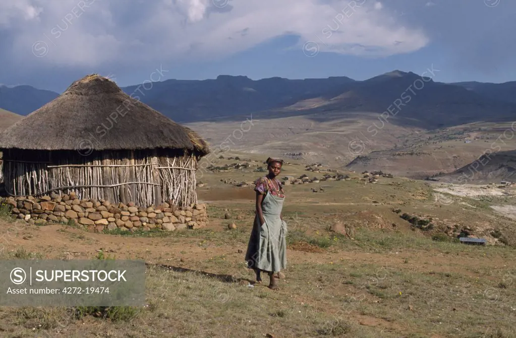Woman outside her Basuto hut at a village in the Maluti Mountains.