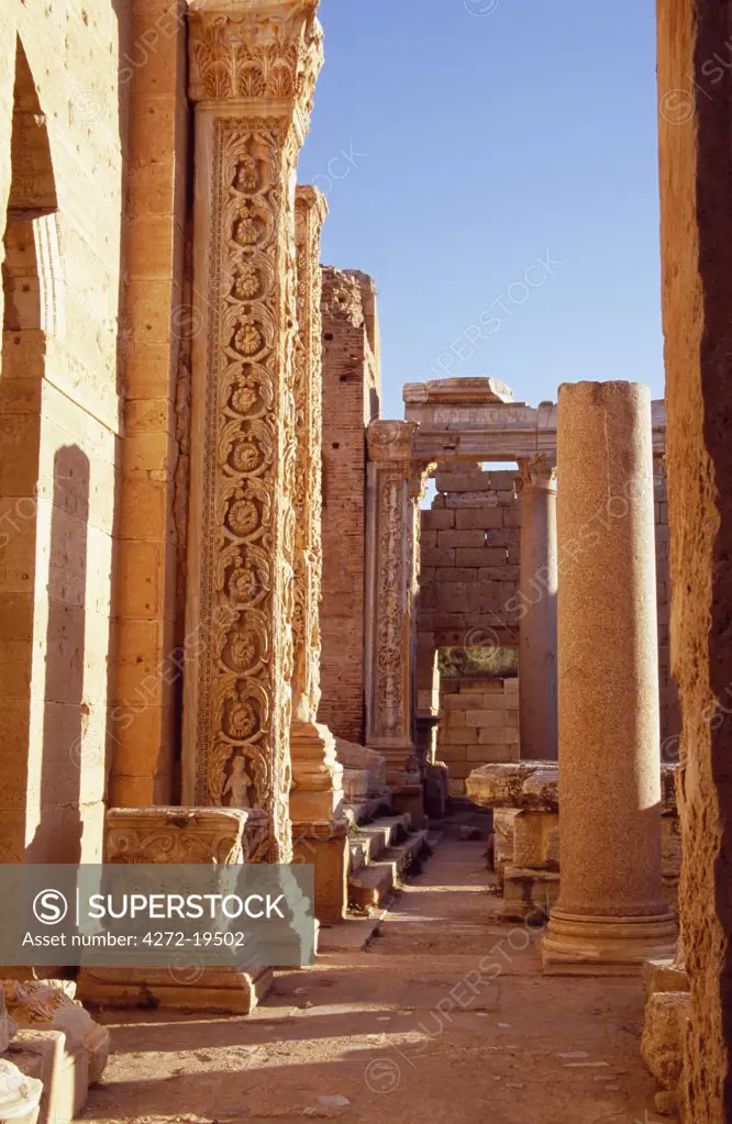 The entrance to the Severan Basilica from the Severan Forum in the ancient Roman city of Leptis Magna.  One of the four pilasters flanking the apses at each end of the Basilica shows the detailed stone carving of vine scrolls.