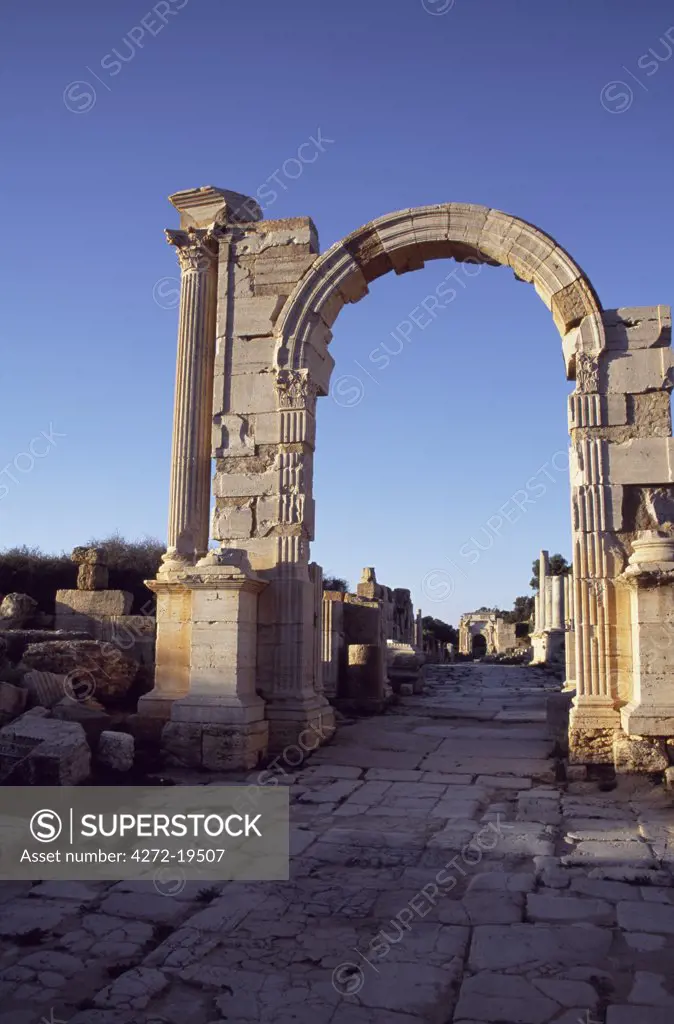 The Trajan Arch built in AD109-110 in the ancient Roman city of Leptis Magna.   The Severan Arch, one of the great works of roman sculpture, can be seen behind.