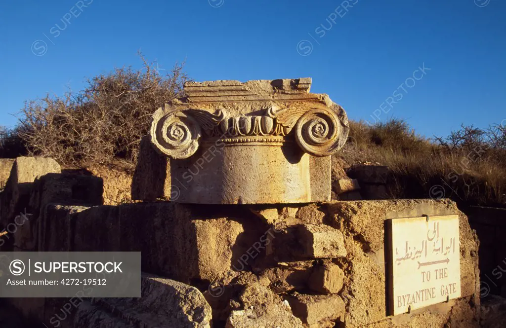 Detail of the top of a column carved with a scroll, placed on the corner of the street leading to the Byzantine Gate in the ancient Roman city of Leptis Magna.