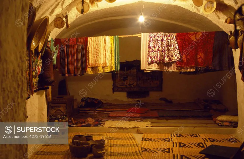 Interior of a bedroom in a Berber house, in the Jebel Nafusa.  Behind the carpet at the back of the room was an alcove where the washing fcilities would be.  These houses were built by ancient Berbers and would accommodate up to three families.  A tunnel led into the house which consisted of living rooms, a kitchen, bedroom and storage rooms.