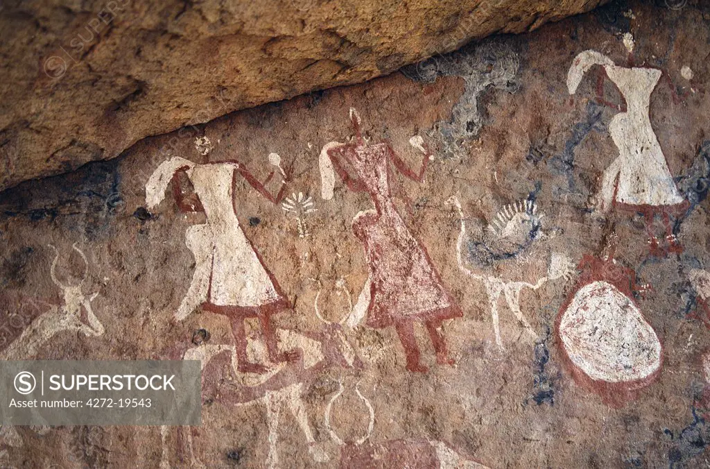 Superb rock painting in the Jebel Acacus in the Libyan Sahara depicting women, ostriches, cattle and flowers