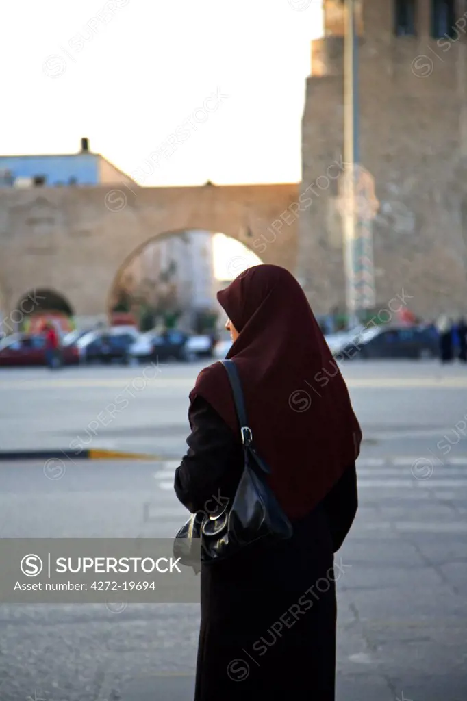 Tripoli, Libya, Tripolitania; A veiled Muslim woman just about to enter Tripoli's Ancient Medina from the Main Gate just off Green Square