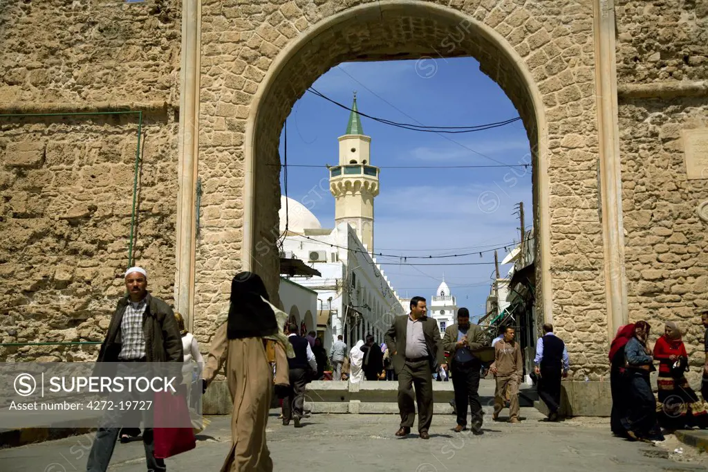 Tripoli, Libya; A man and his wife wearing a 'burka' walking in front of one of the main gates leading to the Old Medina