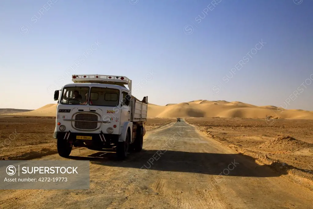 Ghadames, Libya; A truck passing through the only road leading to the desert dunes just outside the old and new towns