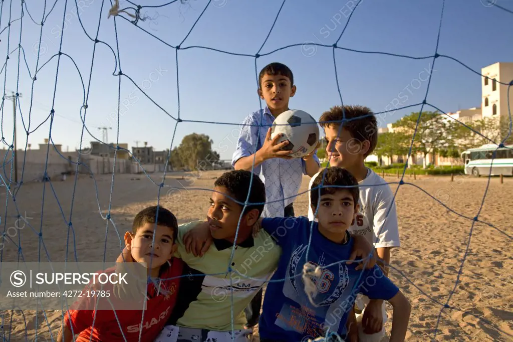 Tripoli, Libya; Children posing for a photograph after a football match in the outskirts of the city