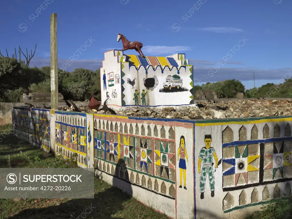 A large Mahafaly tomb.   When respected and wealthy men of the Mahafaly community die, they will have the highlights of their lives perpetuated in colourful paintings adorning their tombs.