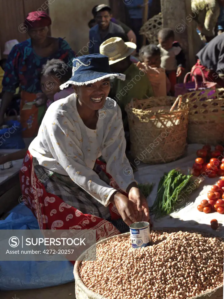 A woman selling vegetables and dried beans at Ihosy retail market, Madagascar