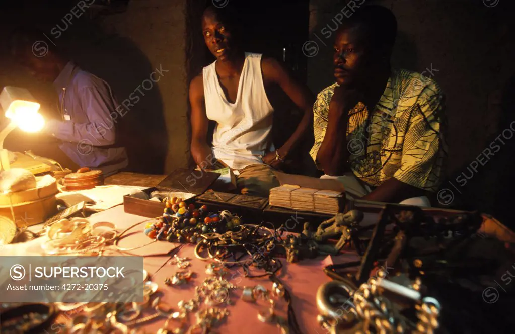 Trader in traditional Malian jewellery displays his goods in a backstreet of D'jenne