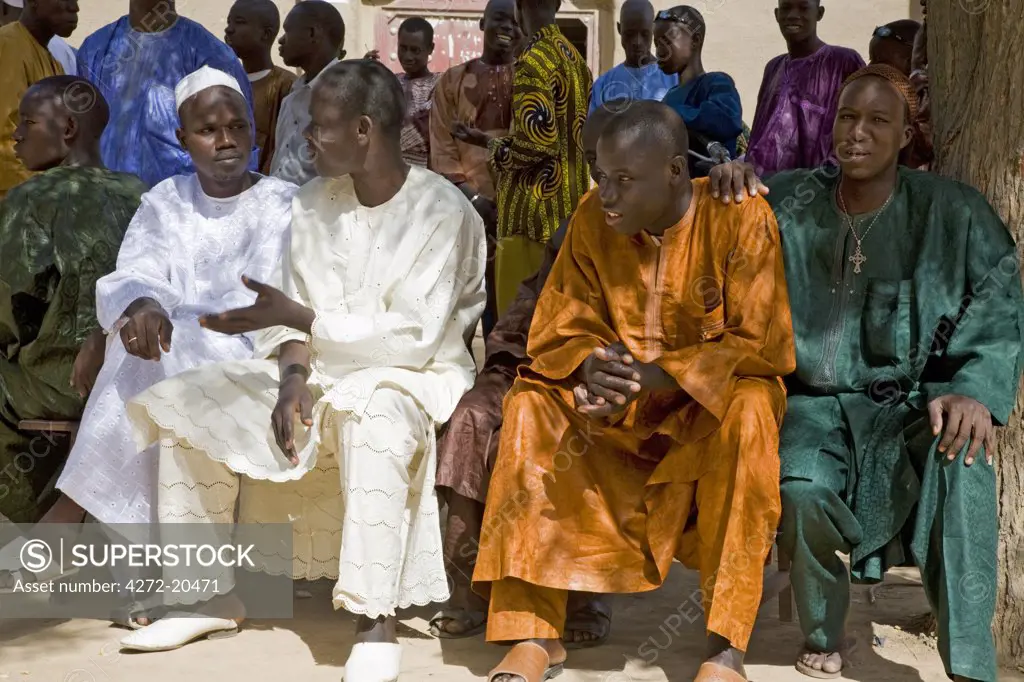 Mali, Djenn_. Smartly dressed wedding guests at Djenn_ .  With a population of about 10,000, Djenn_ is an agricultural town situated on an island in the Niger Inland Delta.  Beautiful mud-brick buildings are a feature of this historic place.