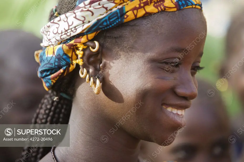 Mali, Douentza. A happy Bella girl wearing gold earrings in her village near Douentza. The Bella are predominantly pastoral people and were once the slaves of the Tuareg of Northern Mali.