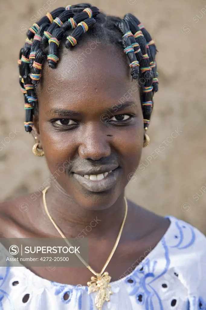 Mali, Gao, Hombori. A young Songhay girl at Hombori with a fetching modern hairstyle.