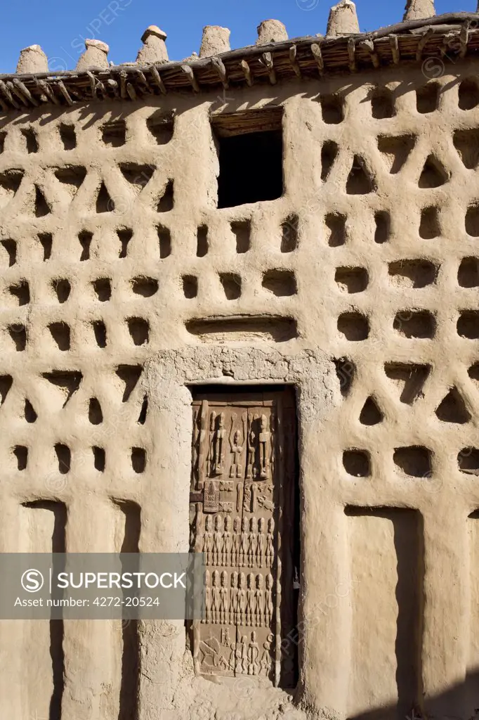 Mali, Dogon Country. A traditional Dogon house with a finely carved door at Sangha, an attractive Dogon village built among rocks on top of the Bandiagara escarpment.
